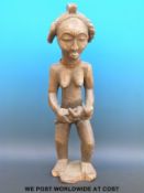 An African tribal Baule maternity figure of a woman holding a child,