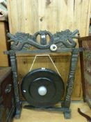 An Eastern gong in carved hardwood frame with dragon decoration,