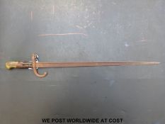 A c1870 French bayonet with the narrow 'T' form blade, with wood grips and brass pommel.