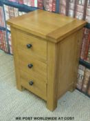 A modern oak bedside cabinet with three drawers (W47 x H67 x D38cm)