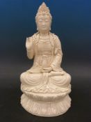 A 19thC Chinese blanc de chine figure of Guanyin seated on a lotus base (40cm tall)