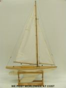 A remote controlled model sailing yacht on stand 'Eagle 1950 1/2 size M class' with planked hull