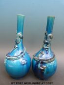 A pair of Chinese bottle vases with blue glaze and relief dragon decoration (26.