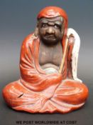 A 19thC Chinese figure of a seated Buddha,