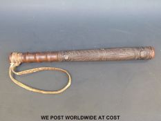 A carved police ceremonial truncheon with possibly Polynesian or similar carving and original