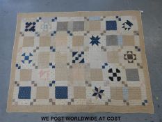 A vintage American Amish handmade patchwork quilt, hand knotted and stitched,