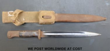 A German bayonet marked F W Heller and 7040K in steel scabbard with canvas frog (overall length 40.