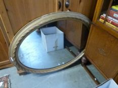An oval gilt framed mirror,