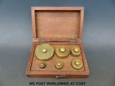 A boxed set of vintage brass weights 16oz - ½oz