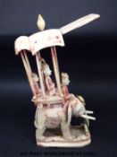 A carved bone chess piece or similar formed as an elephant carrying passengers in a howdah (height