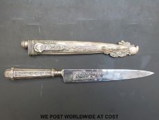 An Argentinian Gaucho boot knife with white metal handle and sheath,