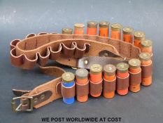 Leather cartridge belt and 12 bore shotgun cartridges.