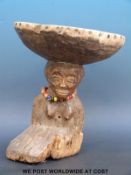 An African figural tribal stool with a kneeling female figure balancing the seat on her head (28cm