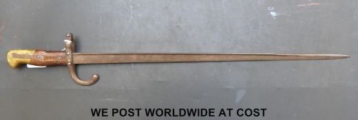 A c1878 French bayonet with the narrow 'T' form blade, with wood grips and brass pommel.