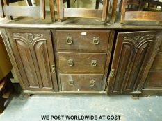 An Art Nouveau oak dresser base with three drawers flanked by cupboards (H97 x L152 x W54cm)
