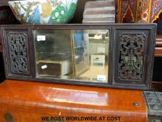 A mirror in Chinese hardwood frame with fretwork panels (76 x 29cm)