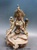A Chinese or Tibetan bronzed model of the goddess Tara seated on a lotus throne (21cm tall)
