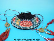 A 19thC Chinese embroidered purse with floral stitching and red tassels