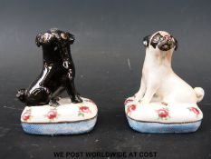A pair of Basil Matthews ceramic pug dogs on cushions (height 6.