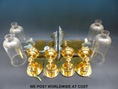A set of four brass wall light fittings,