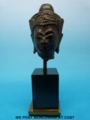 A post Khmer bronze buddha head on mounted base