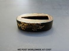 Japanese Edo period fuchi decorated in gilt with flowers on hammered ground.