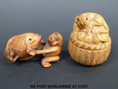 A cherry wood netsuke in the form of a monkey and carp,
