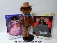 A mohair John Wayne bear together with two dolls,
