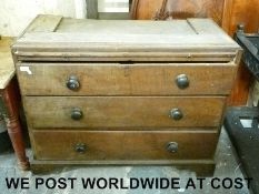 A Georgian oak chest of three drawers with brushing slide to top and a wardrobe base with two