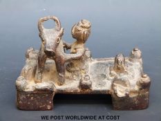 An Ashanti figure milking a cow (8cm tall)