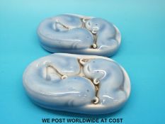 Two unusual Chinese clair de lune porcelain scroll weights modelled as catfish,