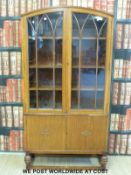 An oak topped bookcase or display cabinet with two glazed doors over two further cupboards (W88 x