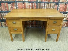 A light oak twin pedestal desk (W137 x H76 x D77cm)