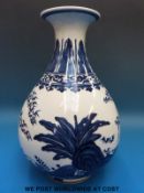 A Chinese blue and white vase decorated with foliage,