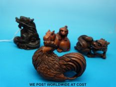 Four carved boxwood and rosewood netsukes,