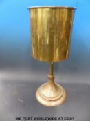 A WWI trench art table made from a very large shell case, marked possibly 'Marz 1918 Dusseldorf',