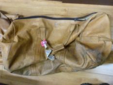 A three-piece leather luggage set comprising two holdalls of different sizes and a suit carrier