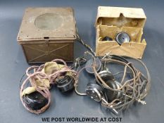 A military radio speaker and headphones