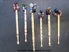 Six 19thC carved bone bobbins including love tokens /marriage examples