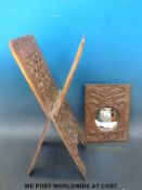 A carved Chinese mirror with dragon decoration together with a book rack