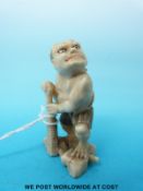 A Japanese Meiji period carved ivory okimono or netsuke of an ogre with a club (5.
