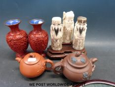 Two Chinese Yixing teapots, three carved scholars on stand,