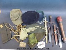 A quantity of militaria including a WWII German grenade, a French 19thC bayonet,