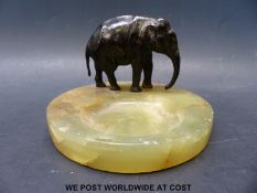 An Art Deco bronze elephant and onyx pin tray