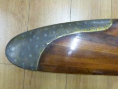 An early 20th century wooden laminated propeller blade with brass tip protector (length 123cm)
