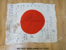 Japanese national company flag (hinomaru yosegaki) decorated with a red circle surrounded by