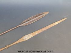 An African metal spear with engraved decoration and flared end (length 138cm) and a similar spear