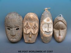 Four African tribal masks (largest 32cm)