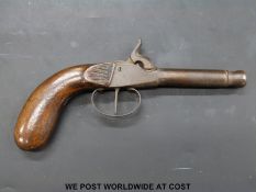 Single barrelled percussion hammer action pocket pistol with 3 inch cannon barrel and carved stock