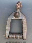 An African twin headed carved ivory hanging figure with revolving pulley spindle (25cm tall)